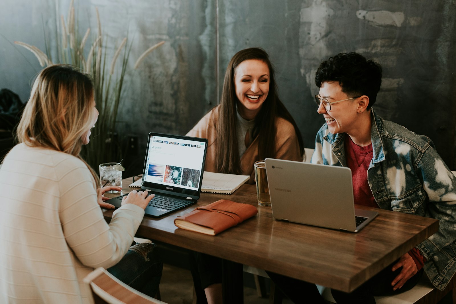 A team collaborating around laptops in a bright workspace